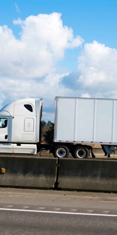 Semi truck near Dallas skyline showing what are the most dangerous trucking routes in Dallas 1 1